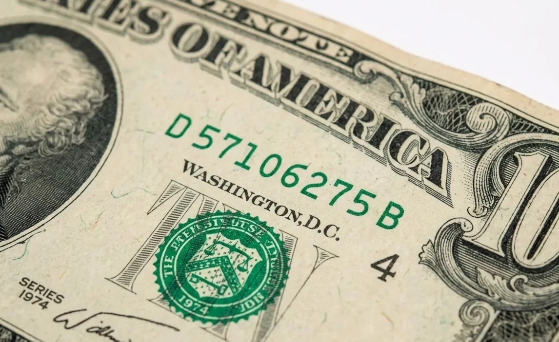Close-up of 10 dollar bill serial number and typography